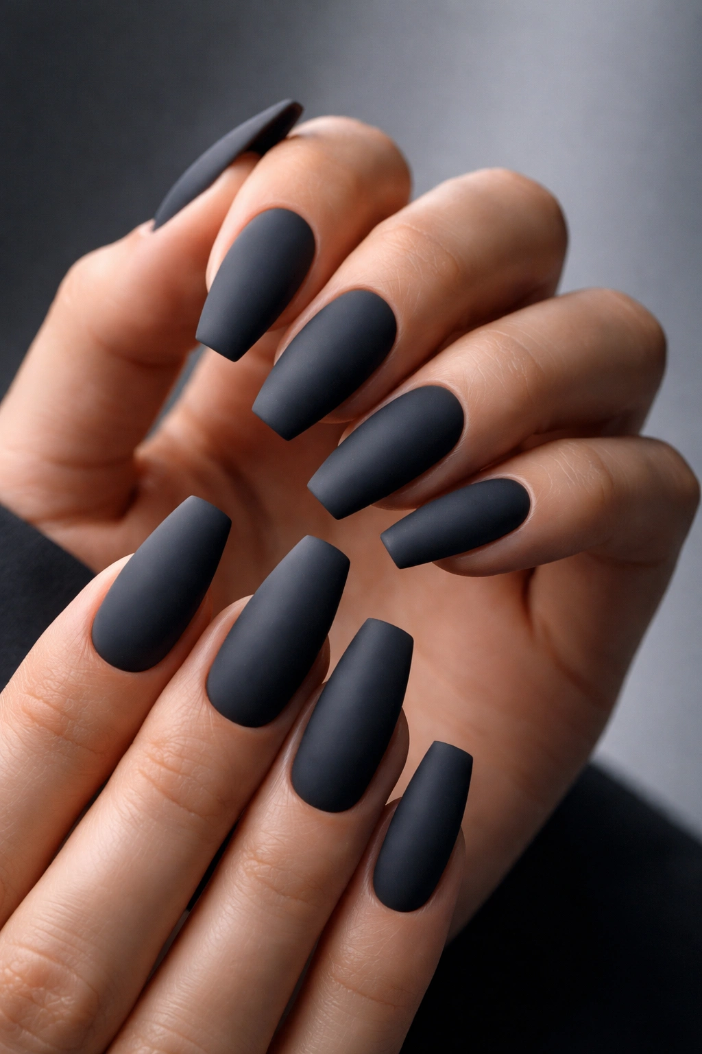 Close-up of matte charcoal gray nails