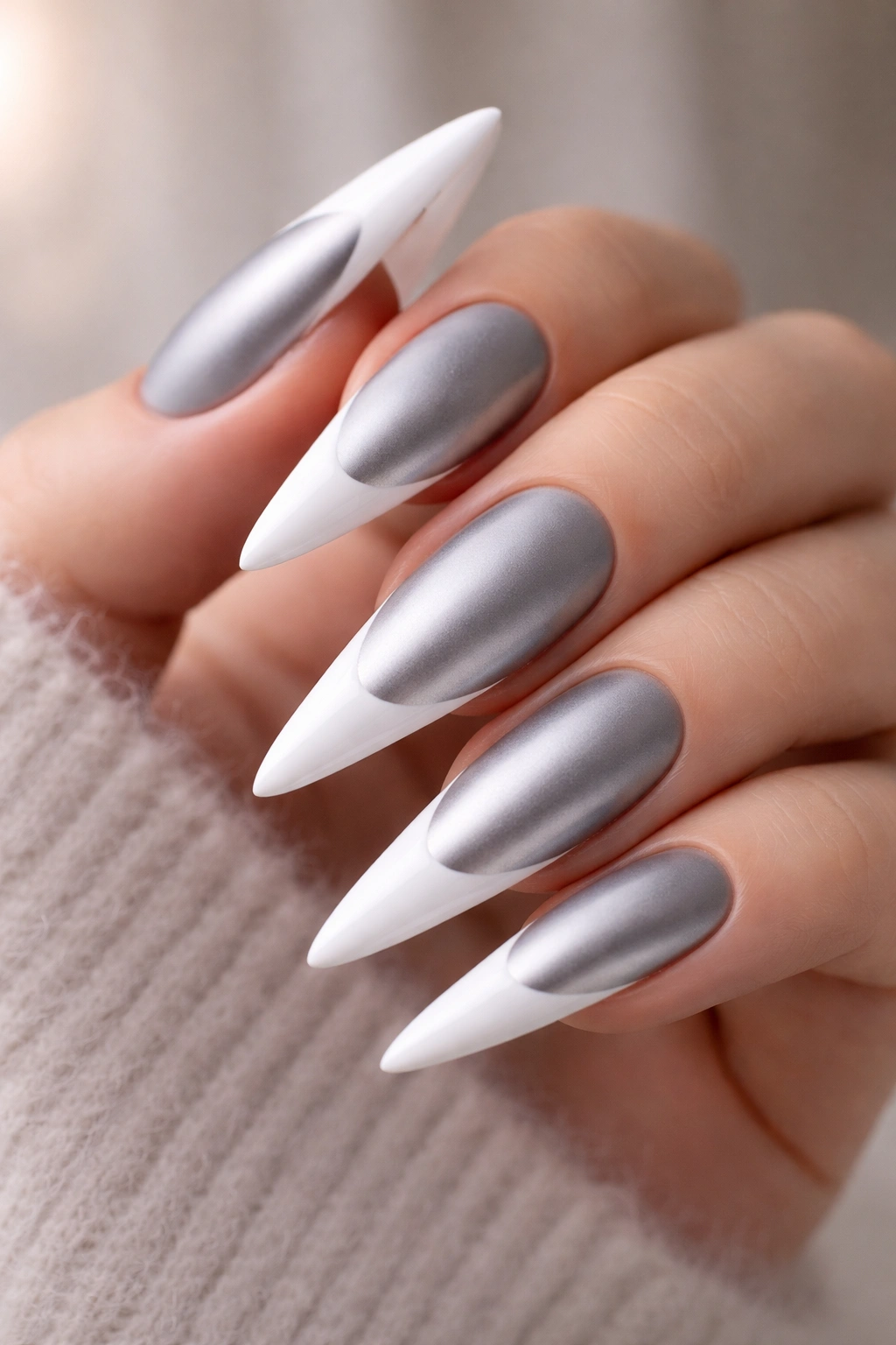 Close-up of matte chrome nails with glossy white tips showing texture contrast