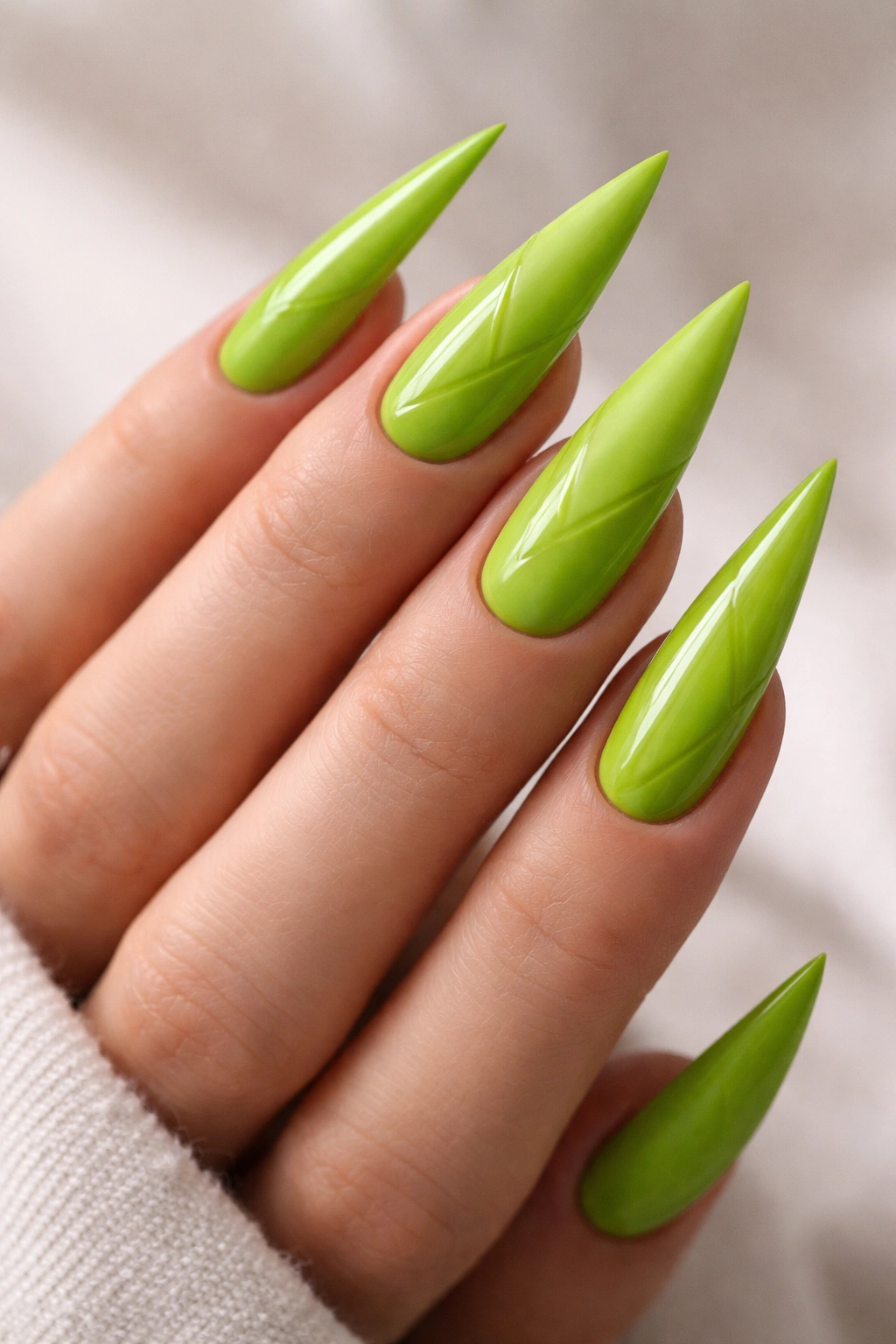 Nails showing matte and glossy lime green finishes for texture contrast