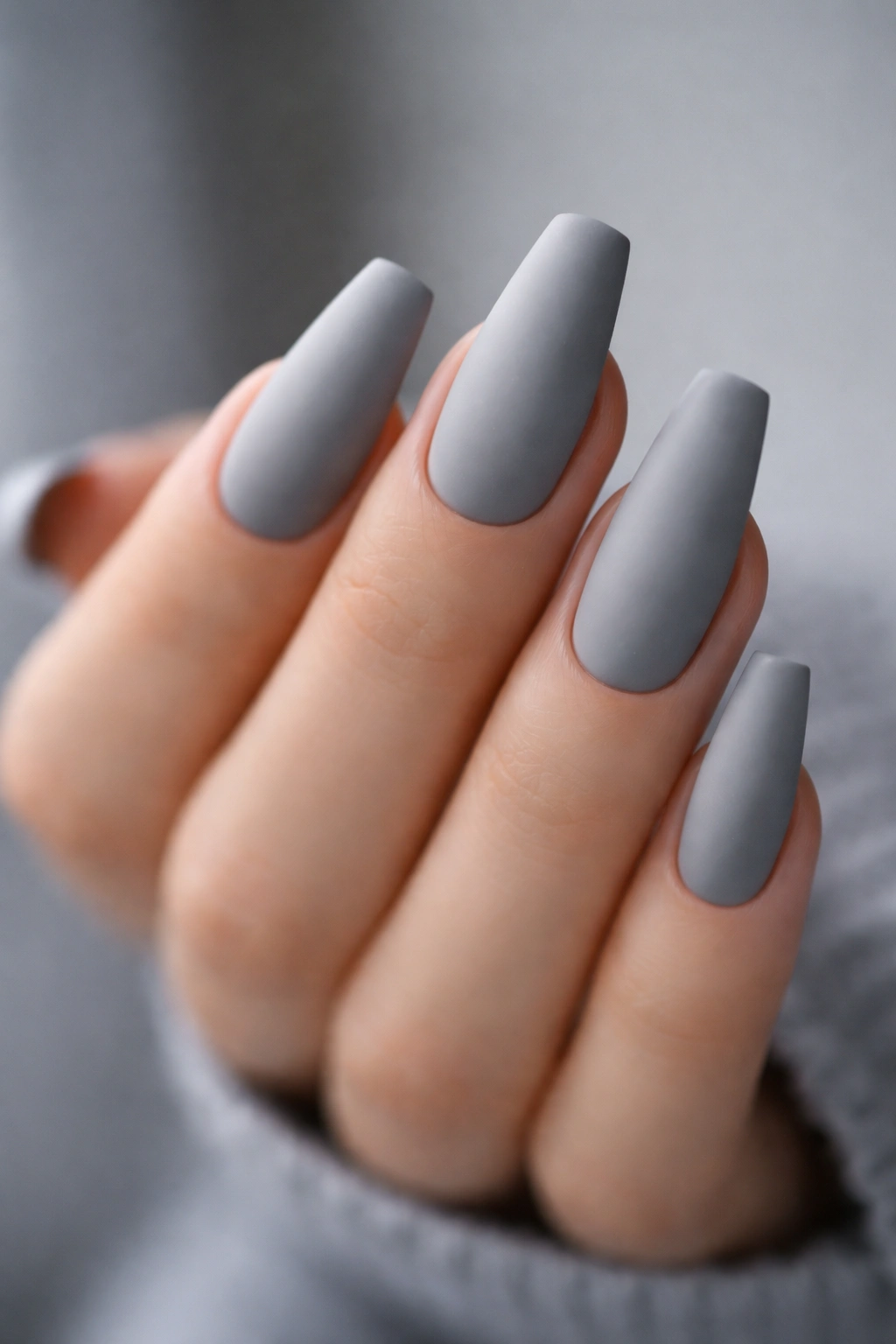 Long ballerina nails in matte concrete grey with soft-edge finish