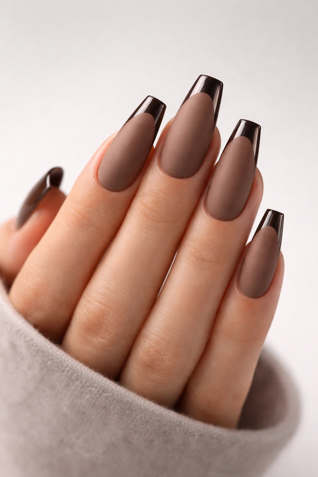 Close-up of matte mocha ballerina nails with glossy tips
