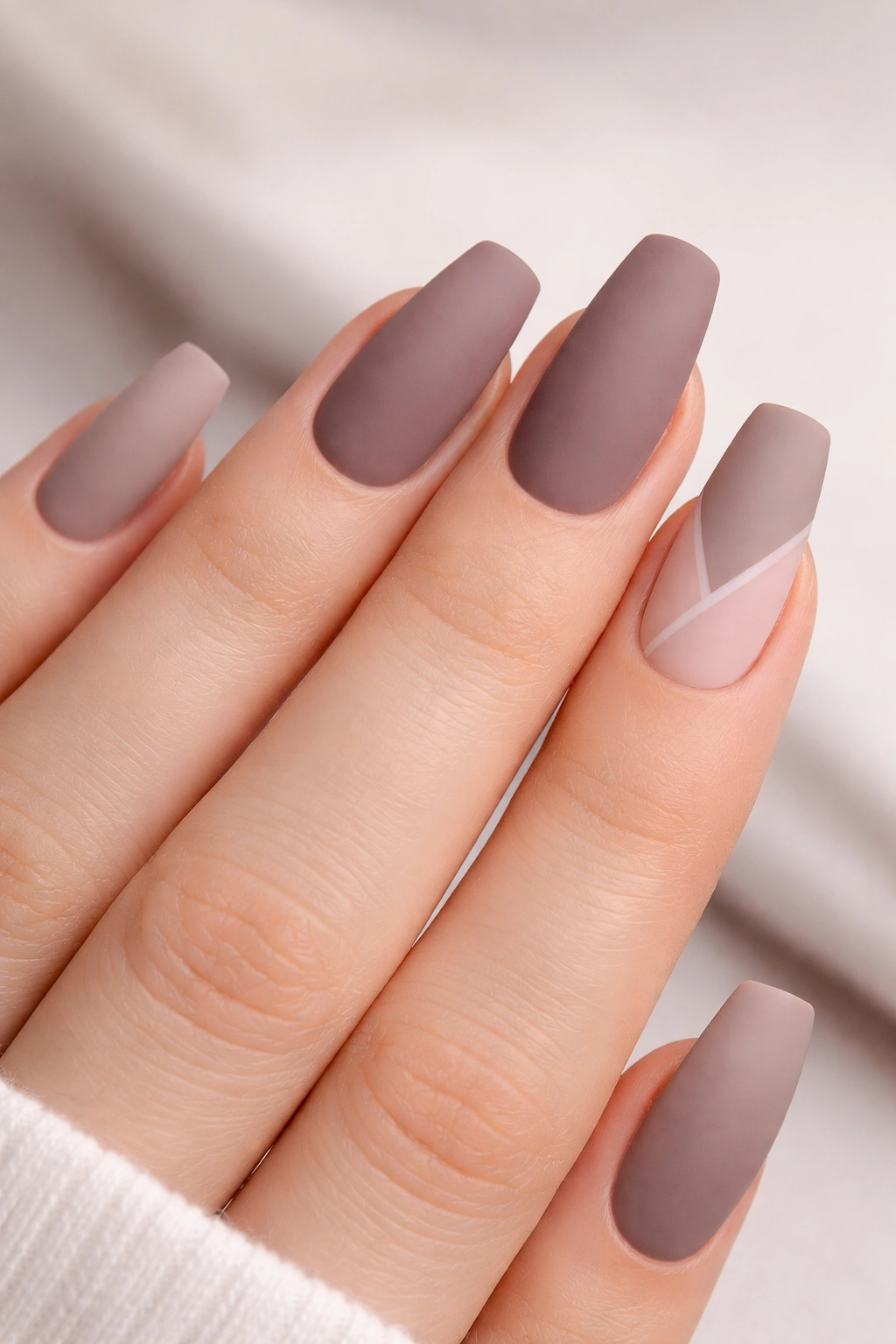 Close-up of medium-length matte acrylic nails with velvety non-gloss finish.