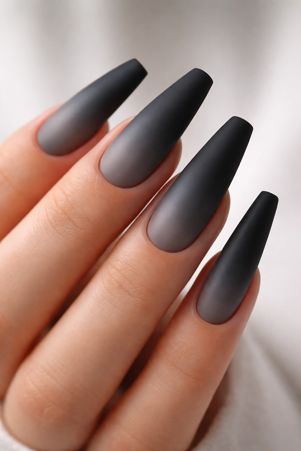 Long matte nails with a charcoal to black ombre