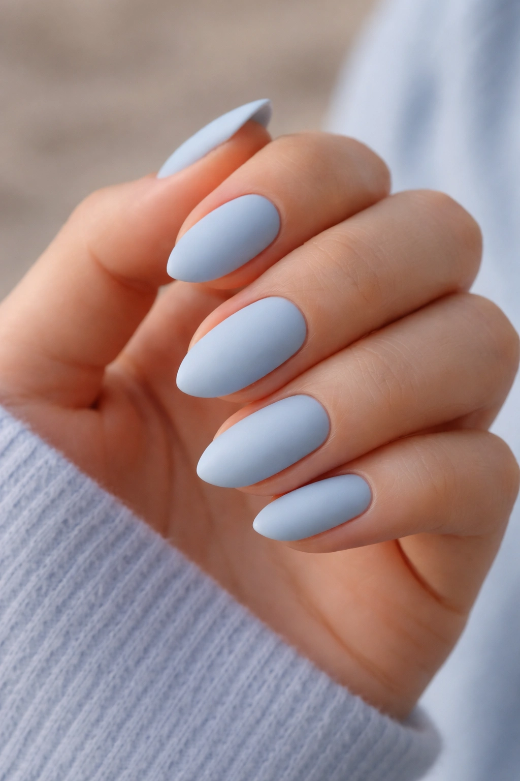 Close-up of matte powder blue almond nails
