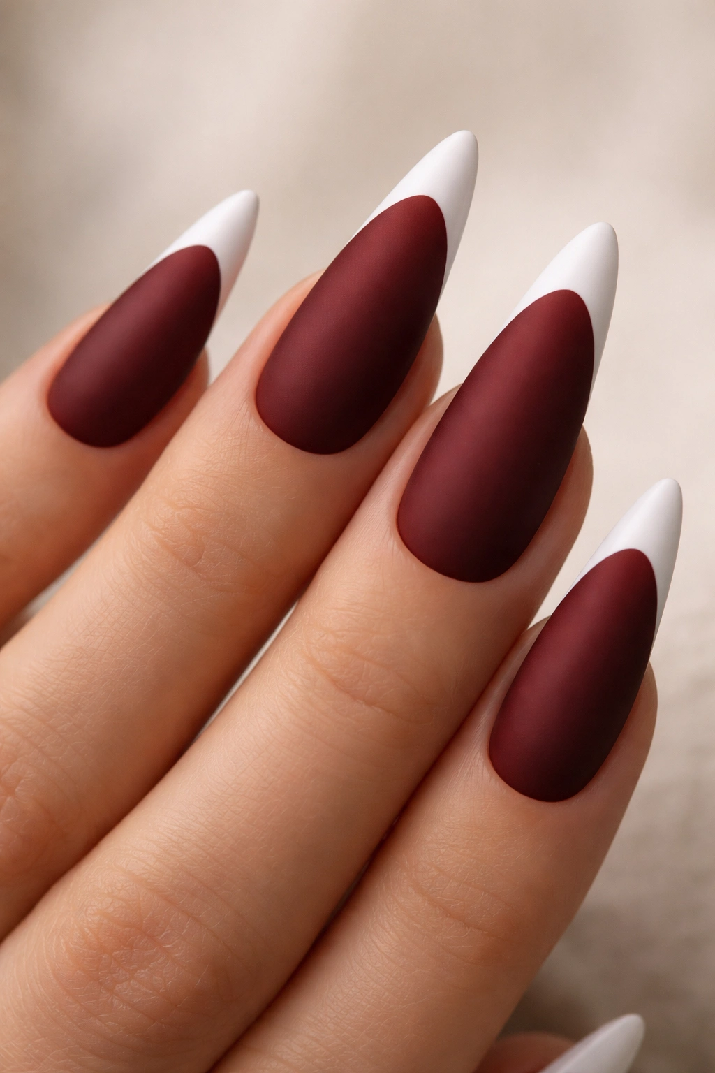 Matte dark red stiletto nails with white tips