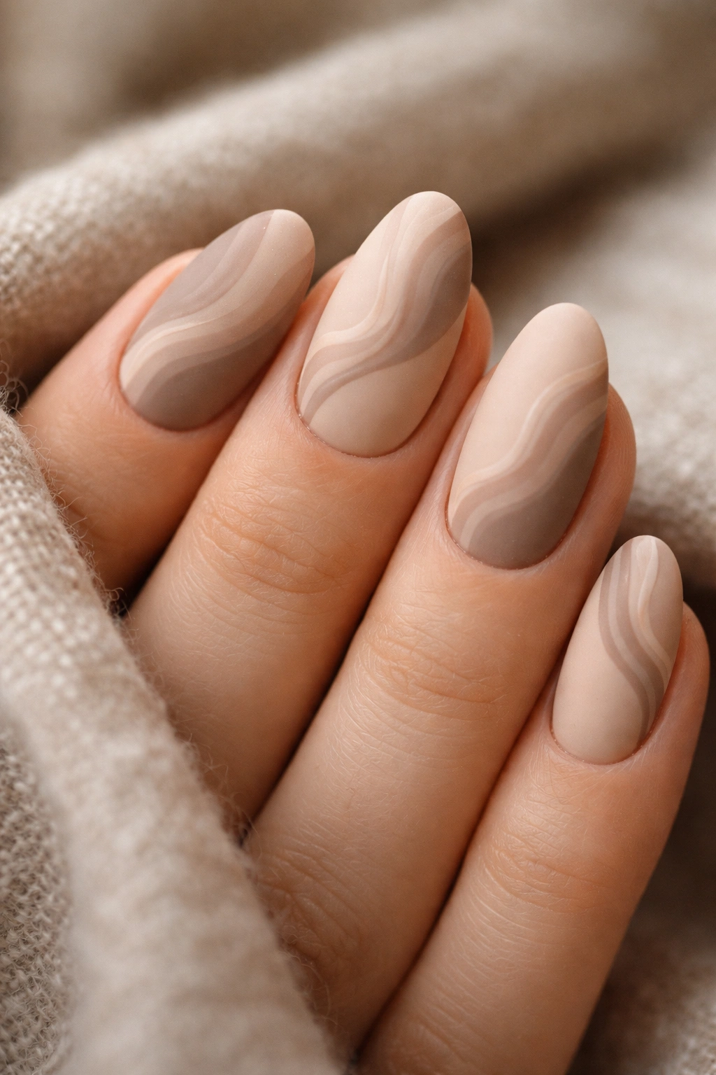 Neutral matte swirl nails on short almond nails