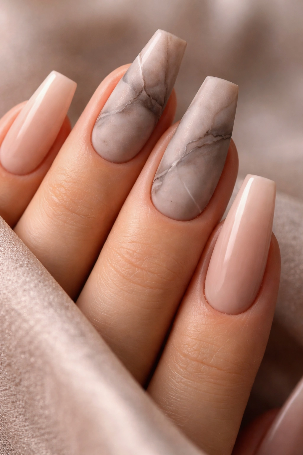 Close-up of matte taupe smoke marble nails with mixed finishes