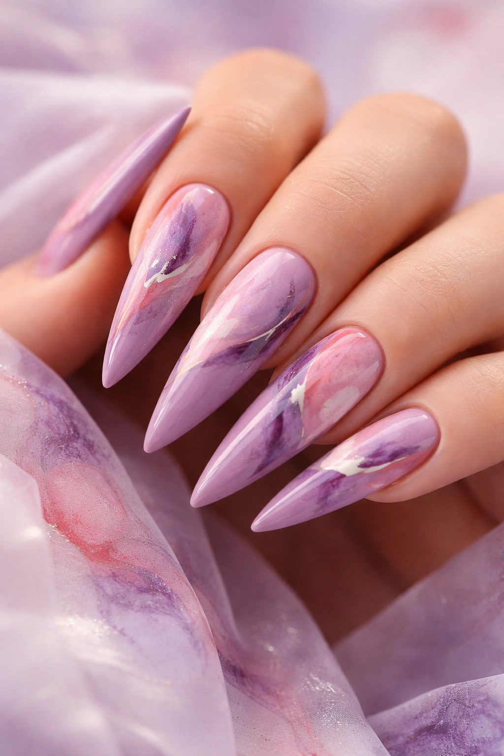 Mauve purple stiletto nails with abstract watercolor patterns