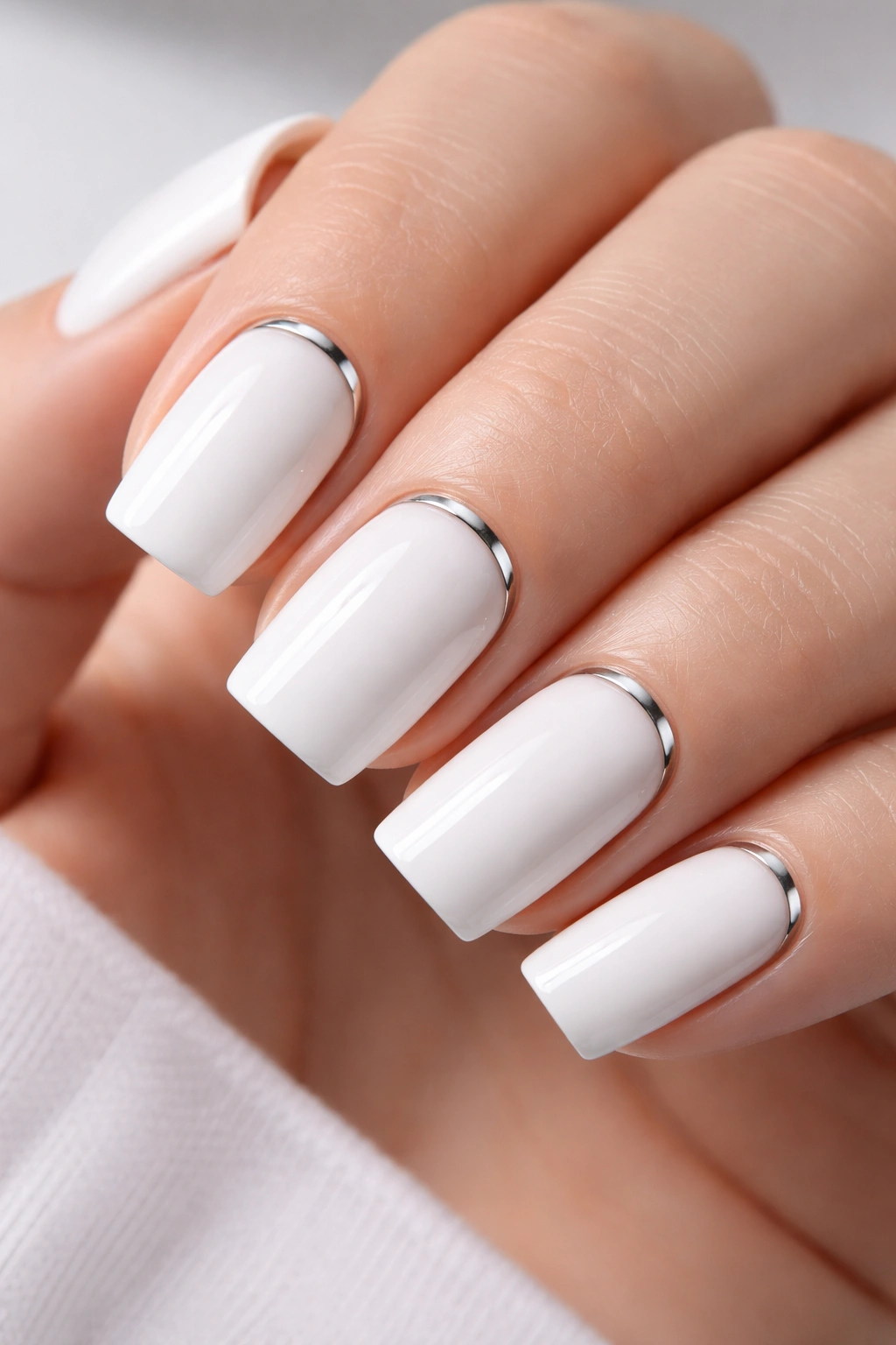 Soft-square nail with a slim metallic chrome stripe at the cuticle