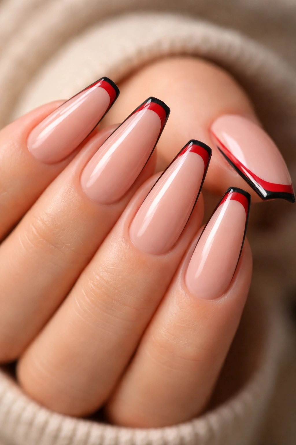 Nude base nails with micro red tips outlined in black.