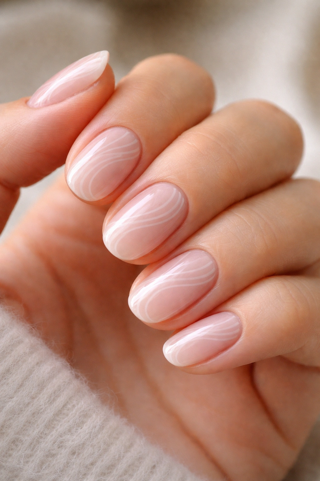 Short oval nails with micro white swirl patterns on nude base