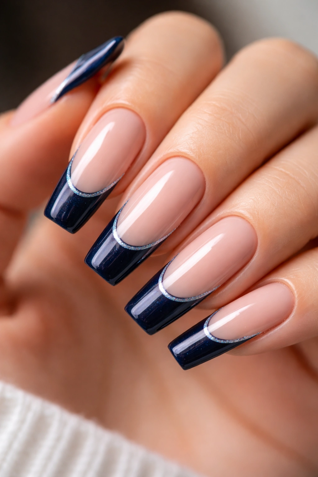 Midnight blue French tip with a fine glitter rim on a nude base
