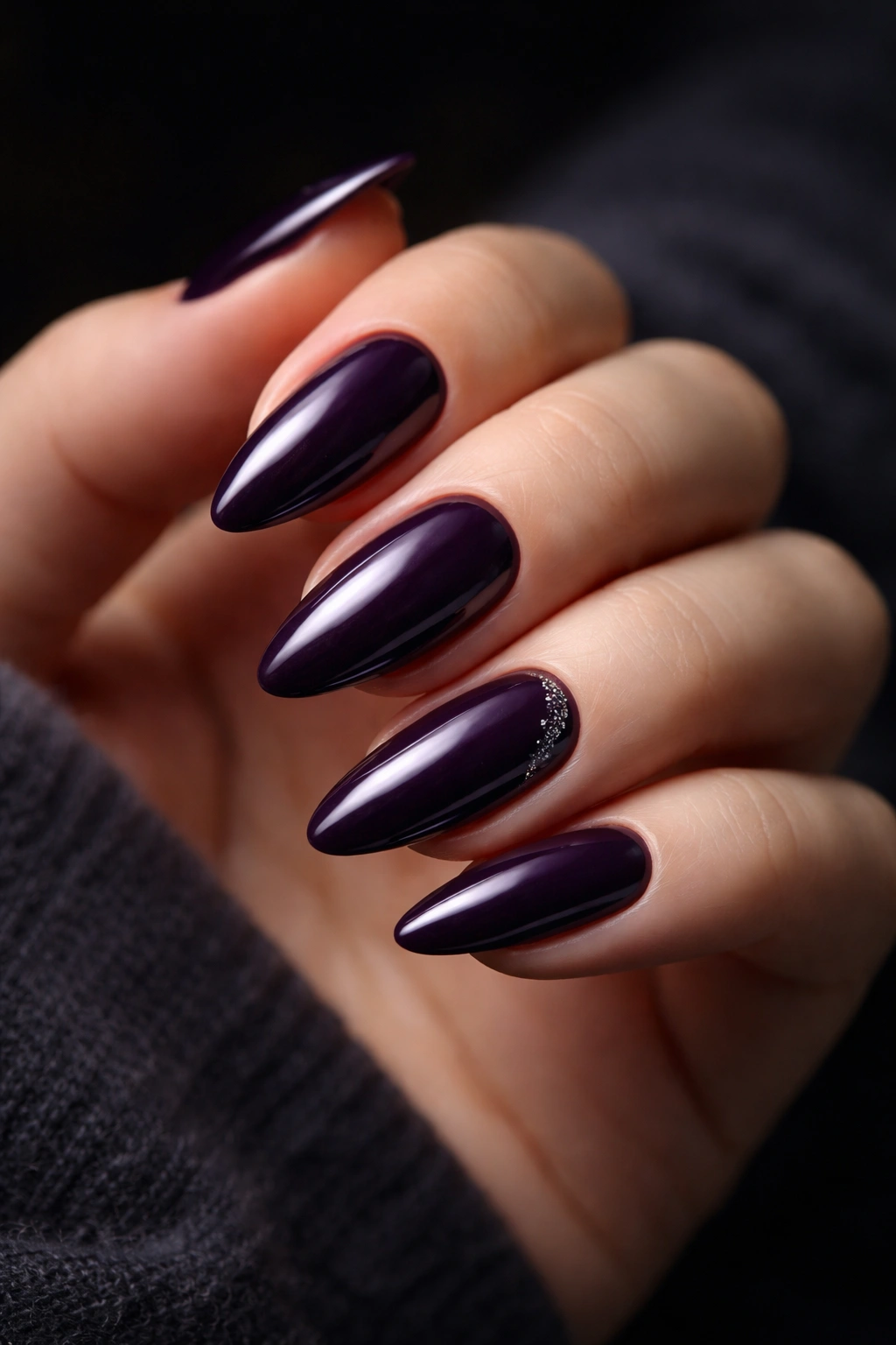 Close-up of midnight plum almond nails in deep purple