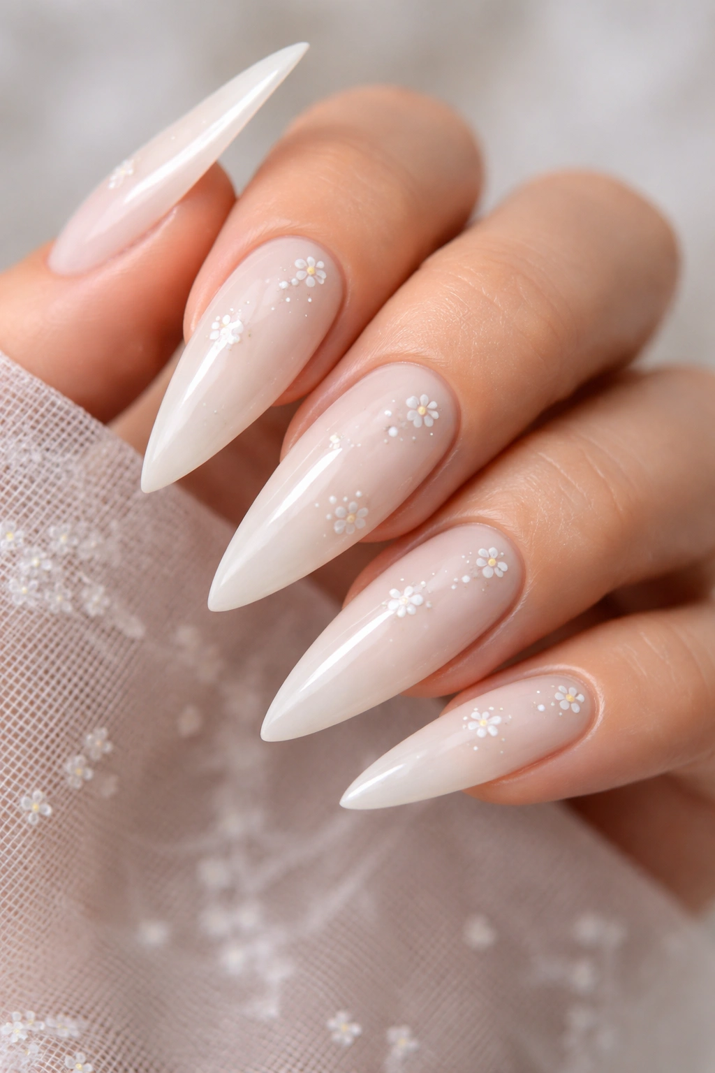 Close-up of milk-white nails with subtle art