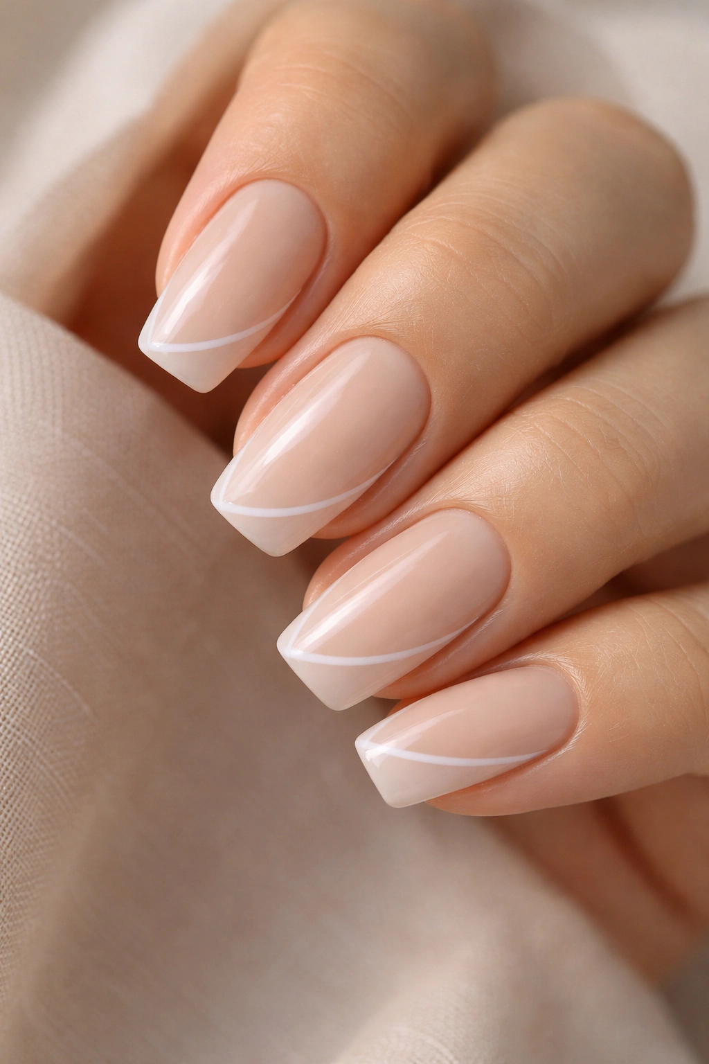 Milky beige nails with diagonal side French line on short ballerina nails