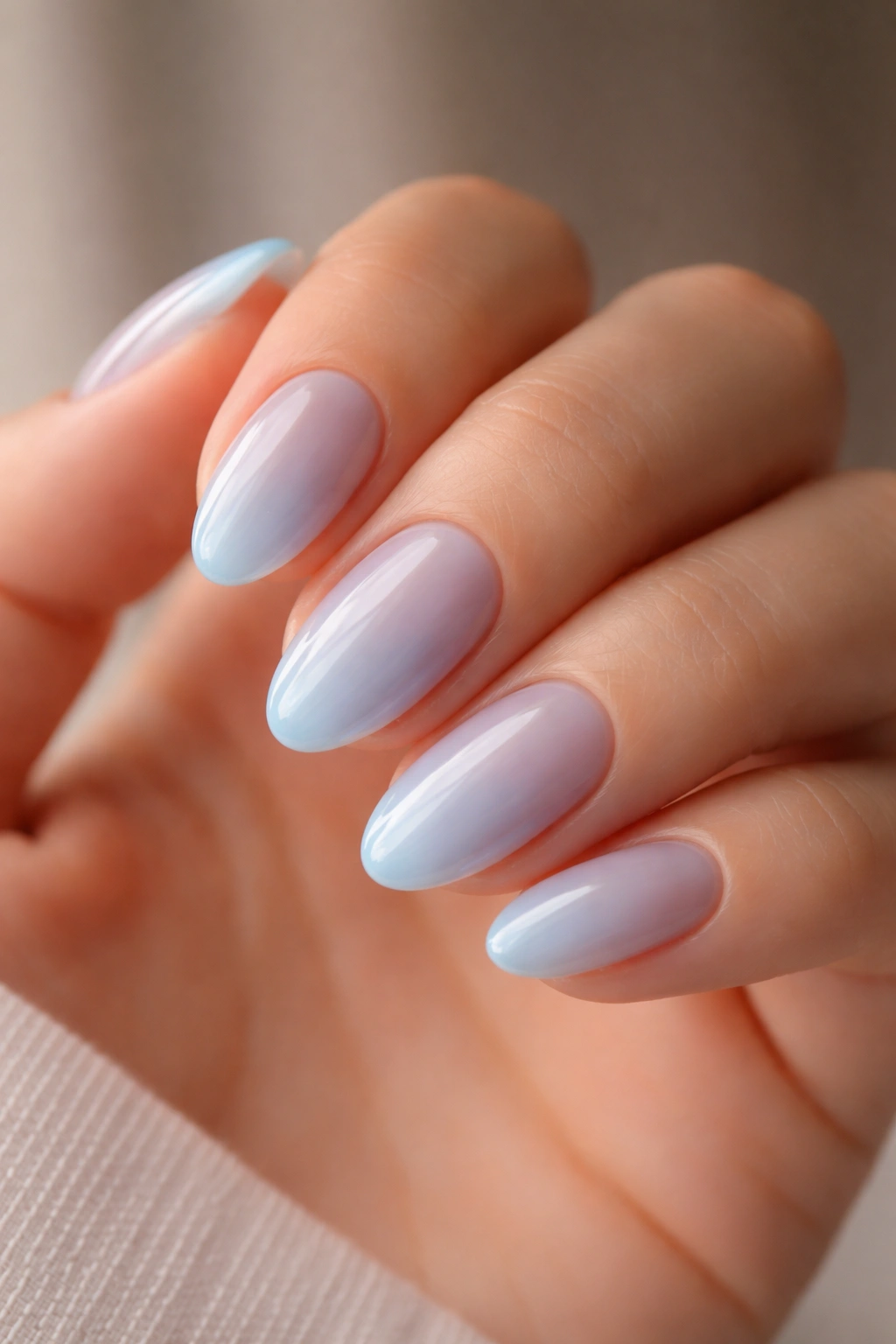 Close-up of milky blue jelly nails on short almond nails