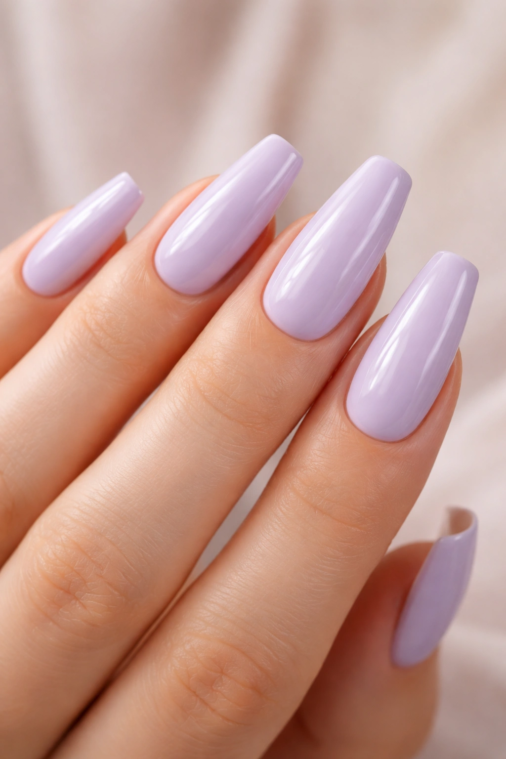 Milky lilac ballerina nails with glossy cream finish