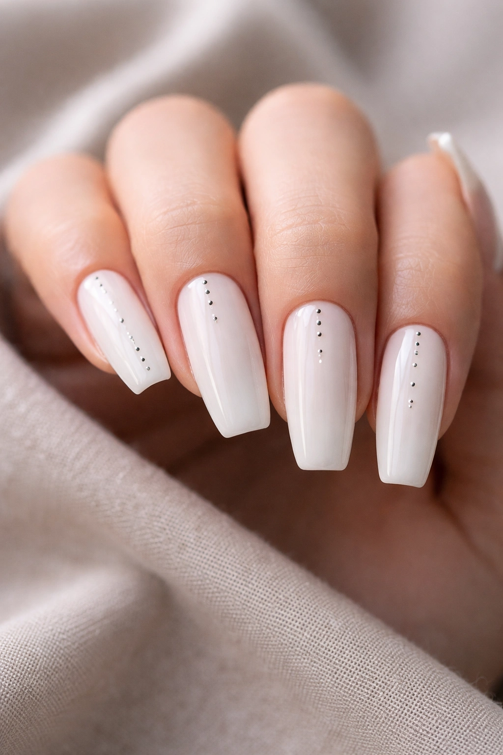 Milky white coffin nails with tiny minimalist dot pattern