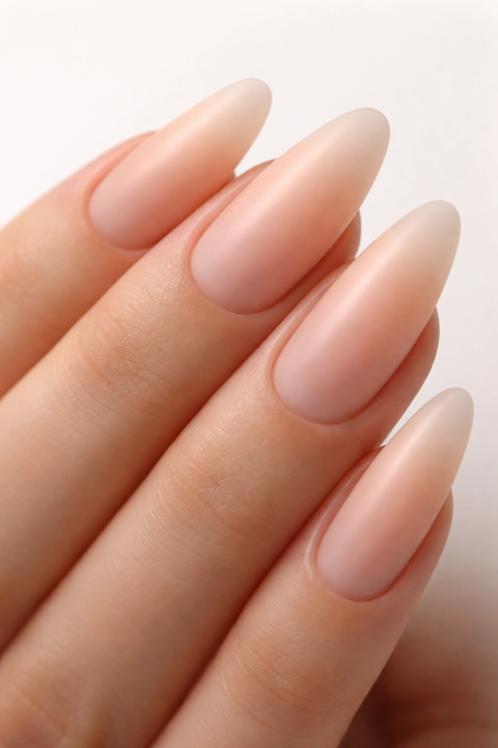 Almond nails with milky peach translucent base and matte finish