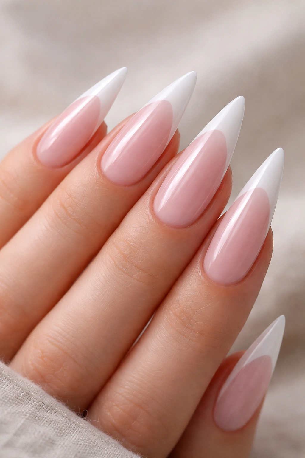 Milky pink semi-transparent base with white tips on stiletto nails