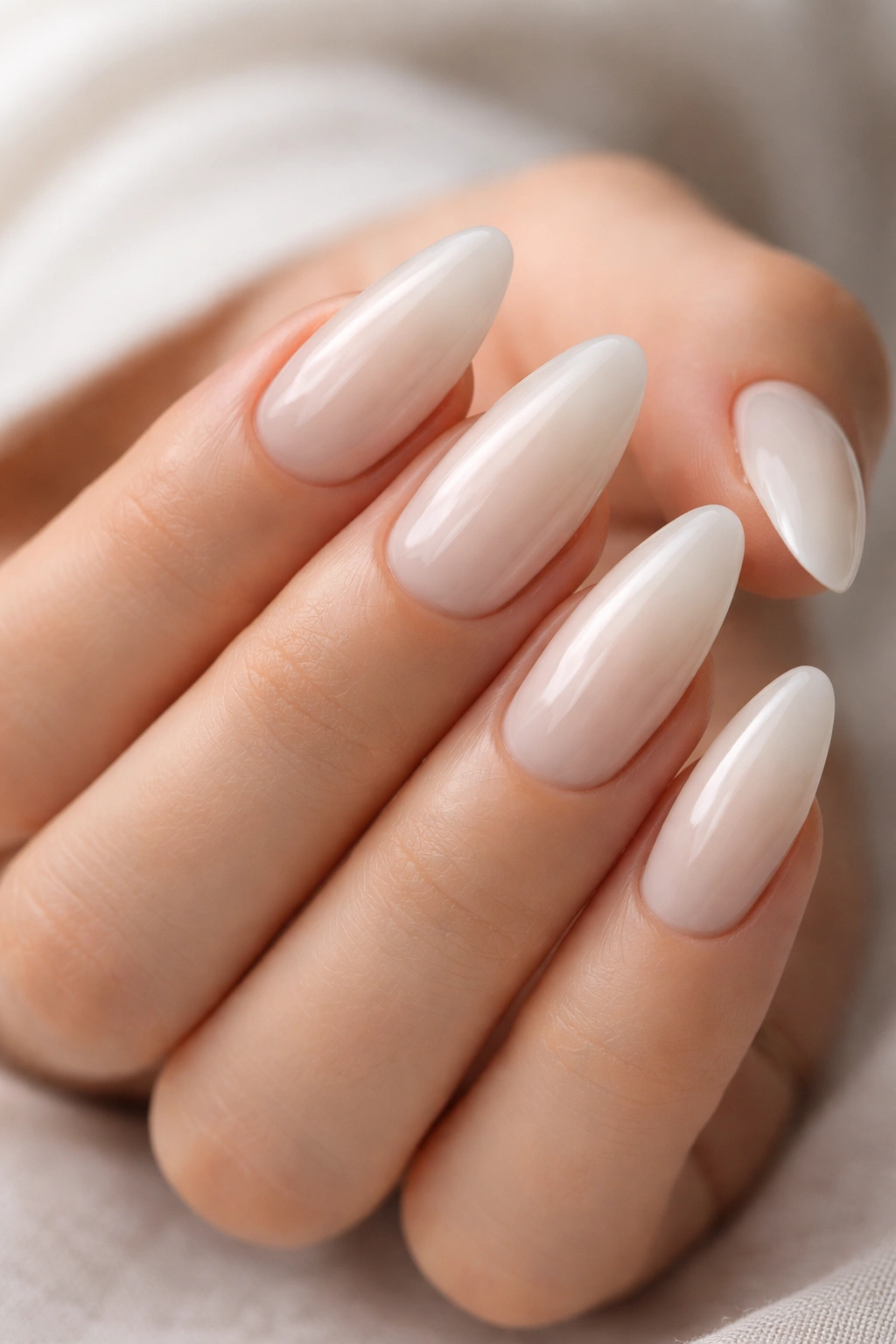 Almond nails with milky white semi-sheer polish