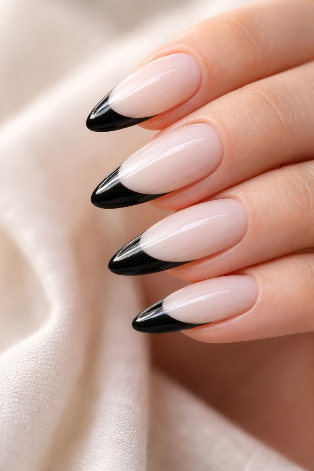 Almond nail with milky white base and glossy black tip