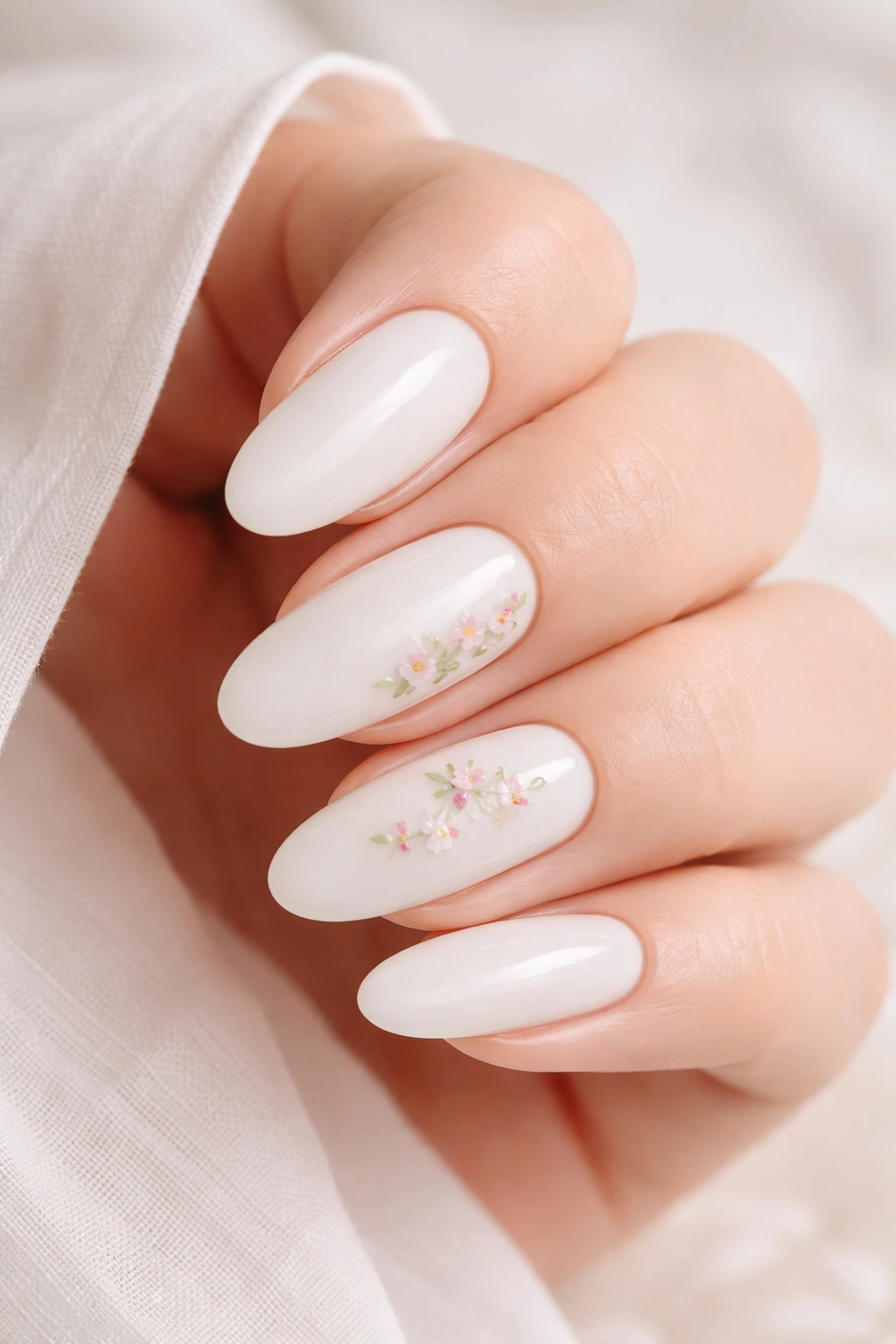 Milky white nails with tiny minimalist floral accents