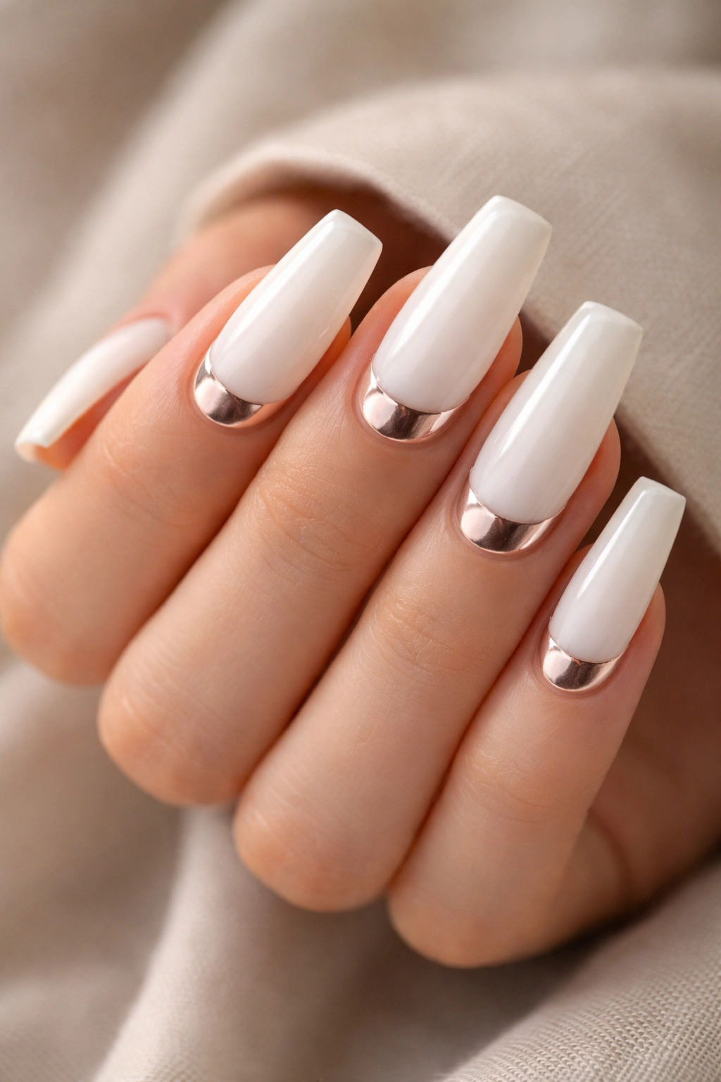 Milky white nails with metallic half-moon at base
