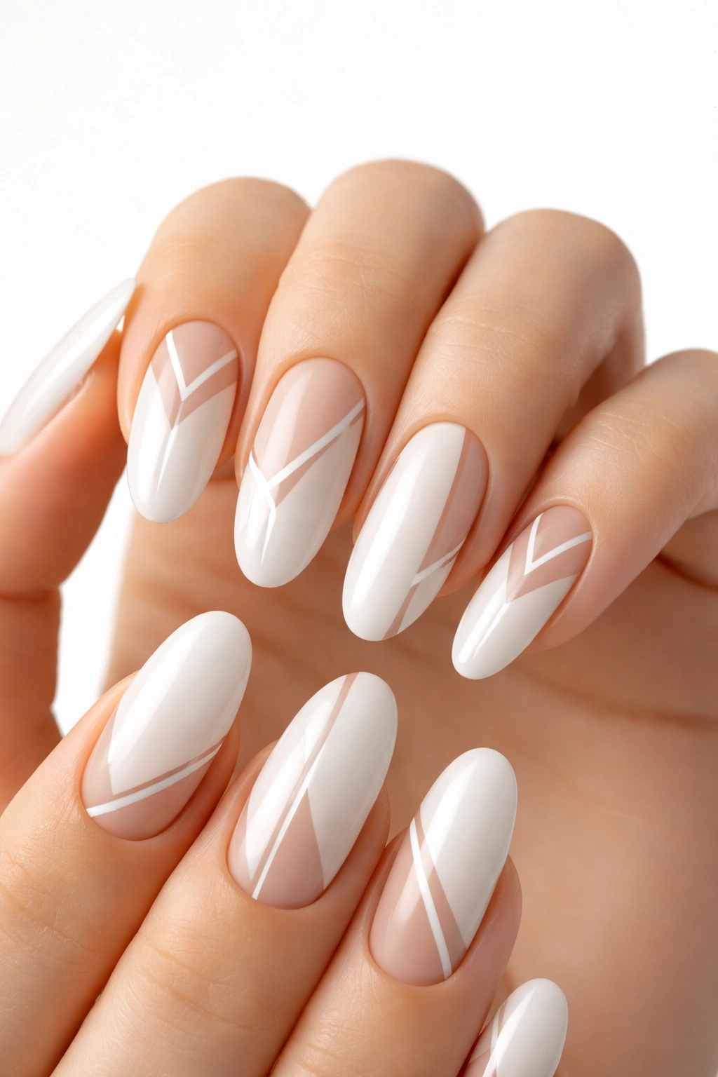 Close-up of milky white long oval nails with minimalist negative-space patterns