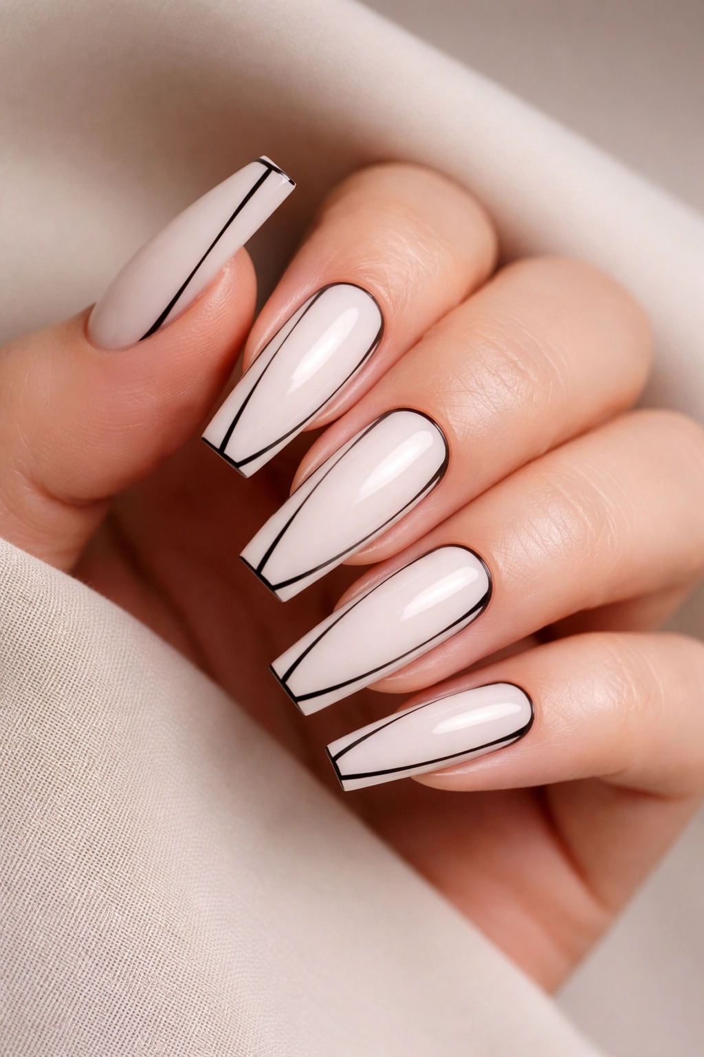 Coffin nails with milky white base and black lines creating negative space