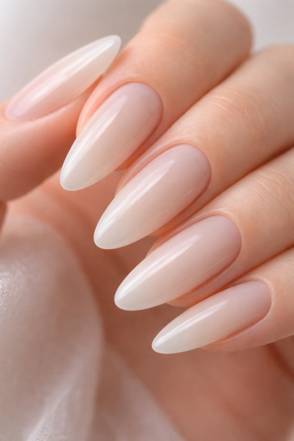 Close-up of tapered oval nails in translucent milky white