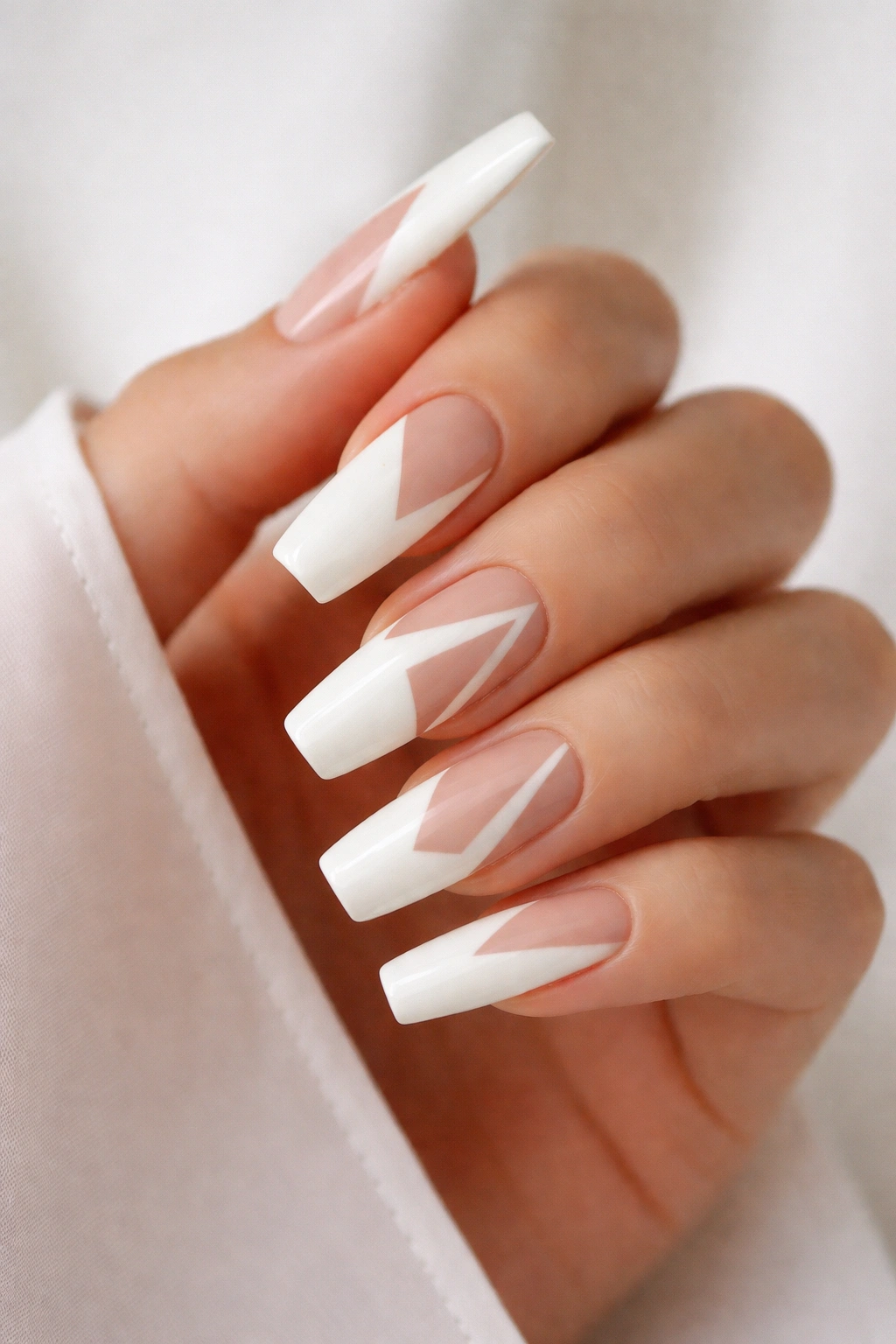 Milky white nails with geometric negative space cutouts