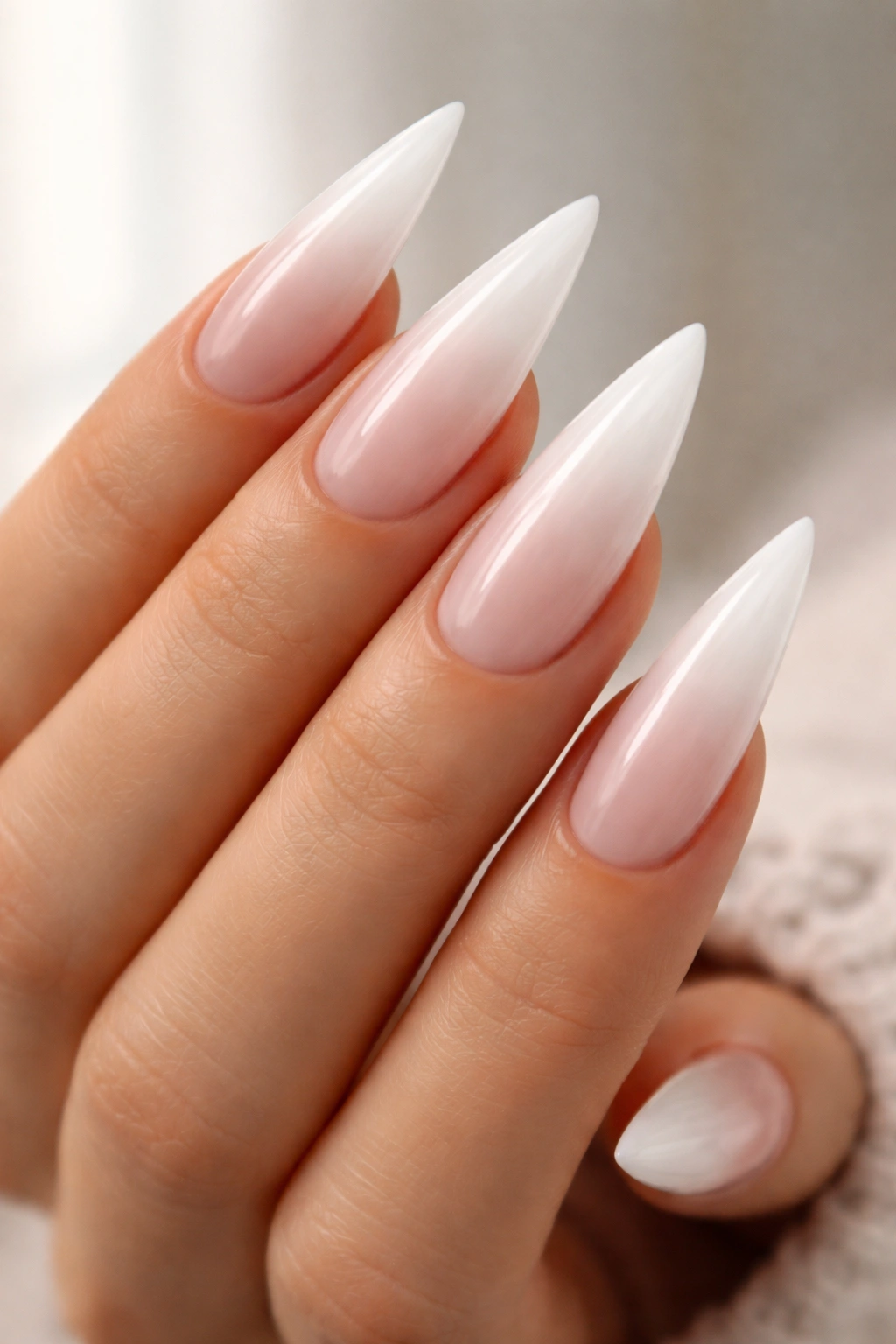 Milky white stiletto nails with gradient ombre tips