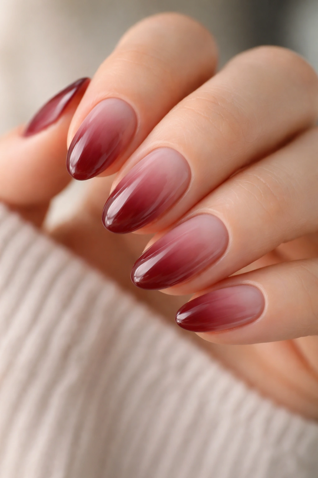 Close-up of short almond nails with milky wine jelly translucent finish