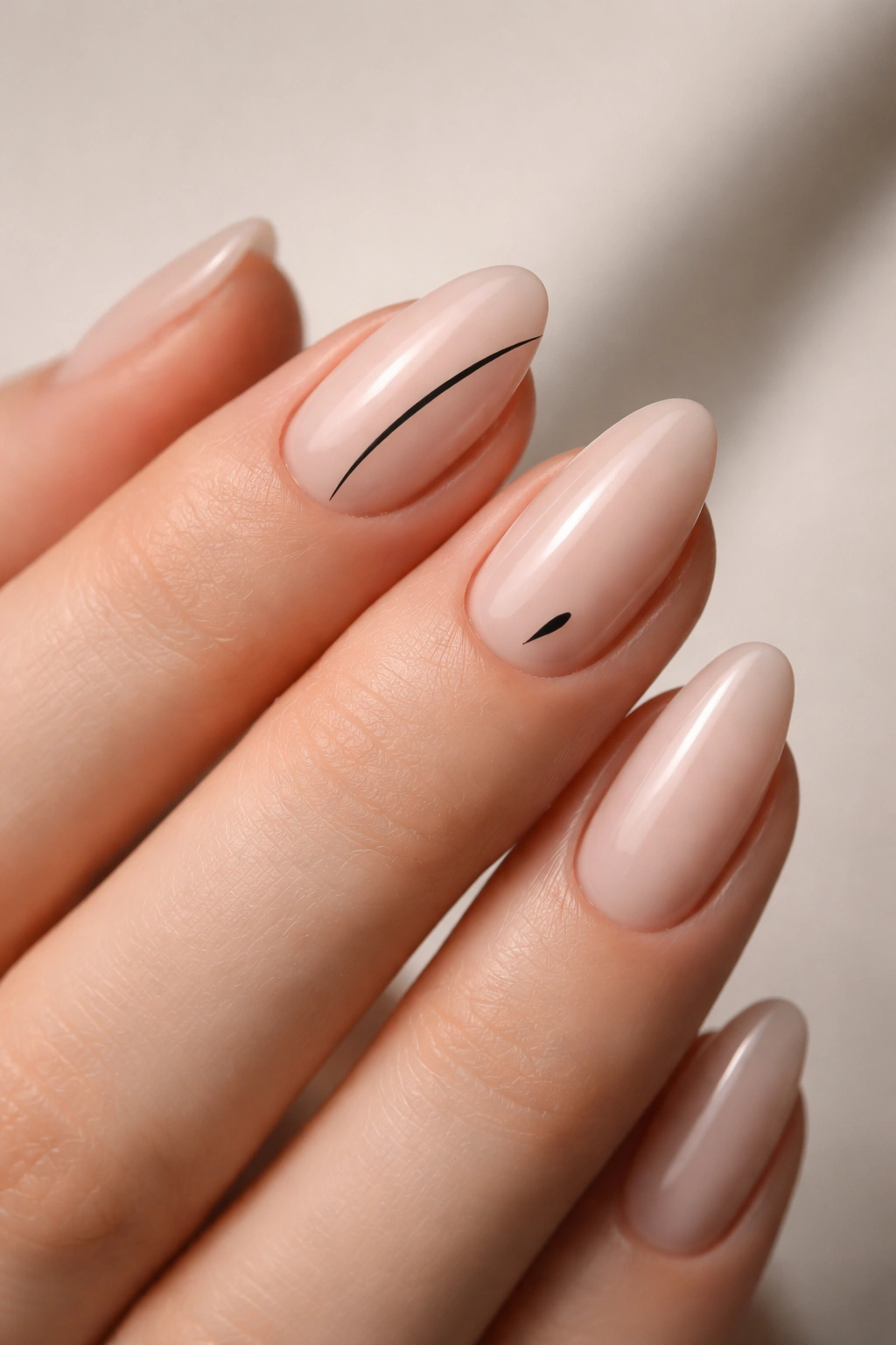 Close-up of short almond polygel nails featuring minimal line art on nude base