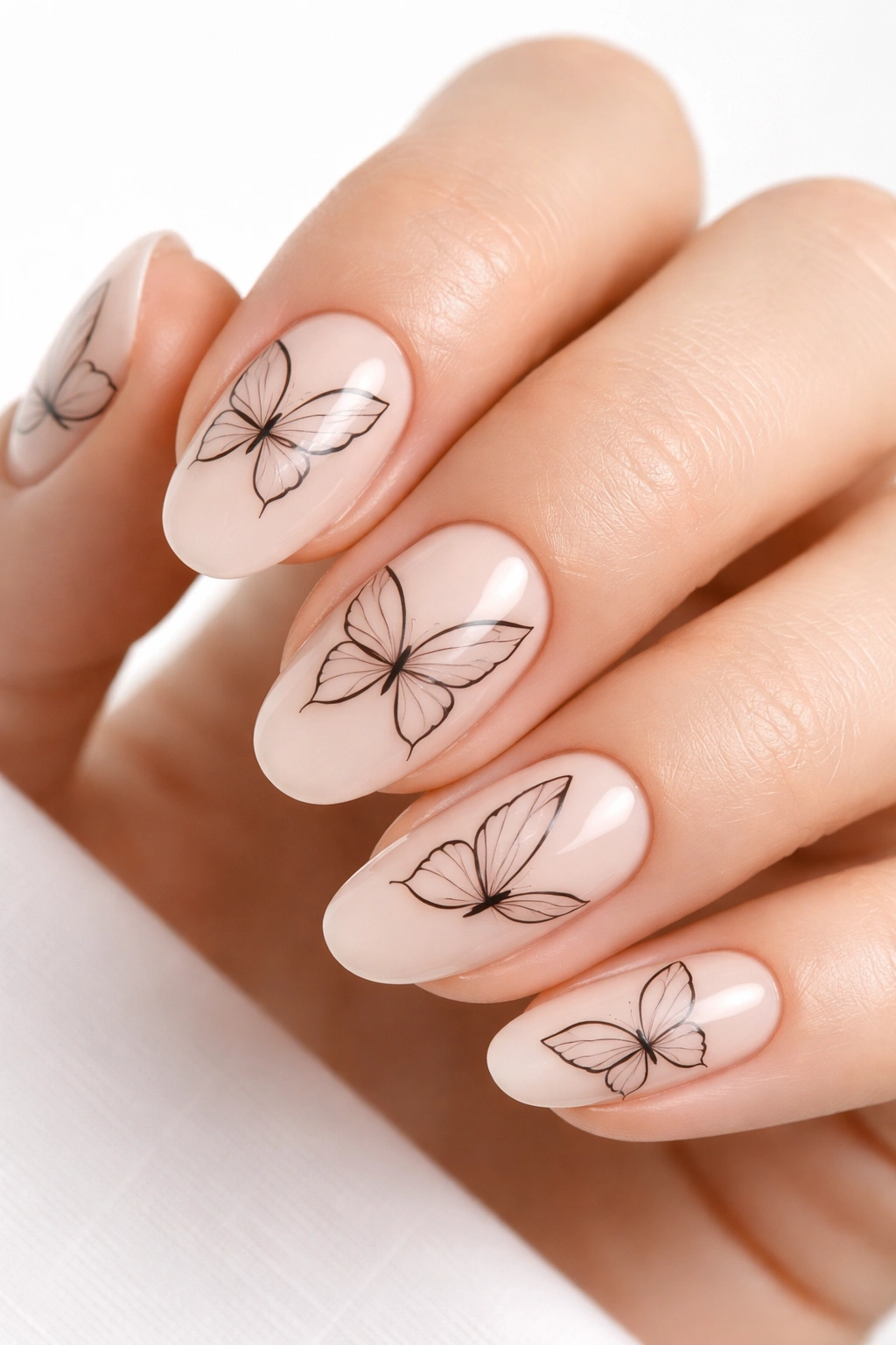 Nails with ultra-thin black line art butterfly silhouettes on nude base
