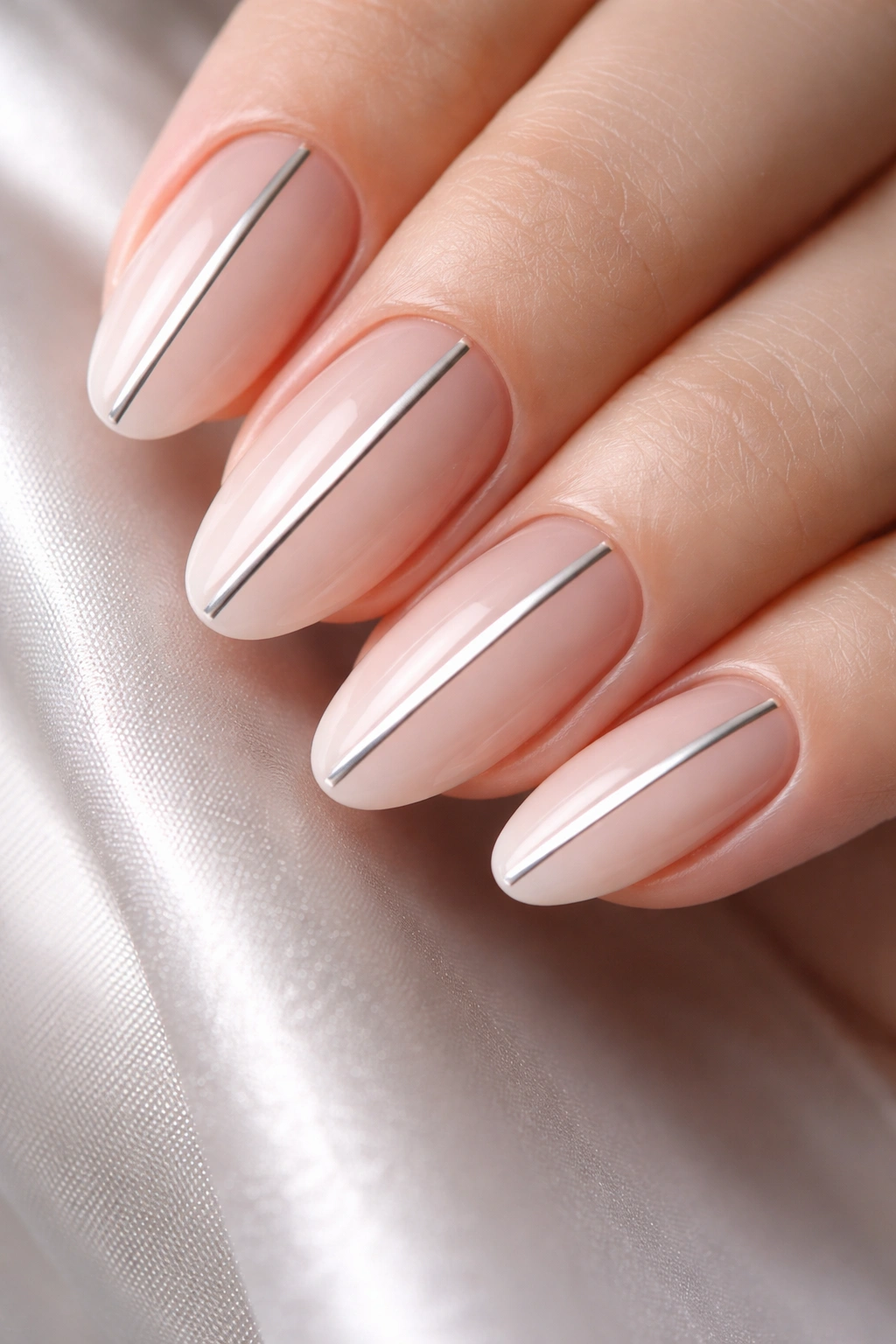Close-up of nails with a single thin chrome line down the center on a nude base