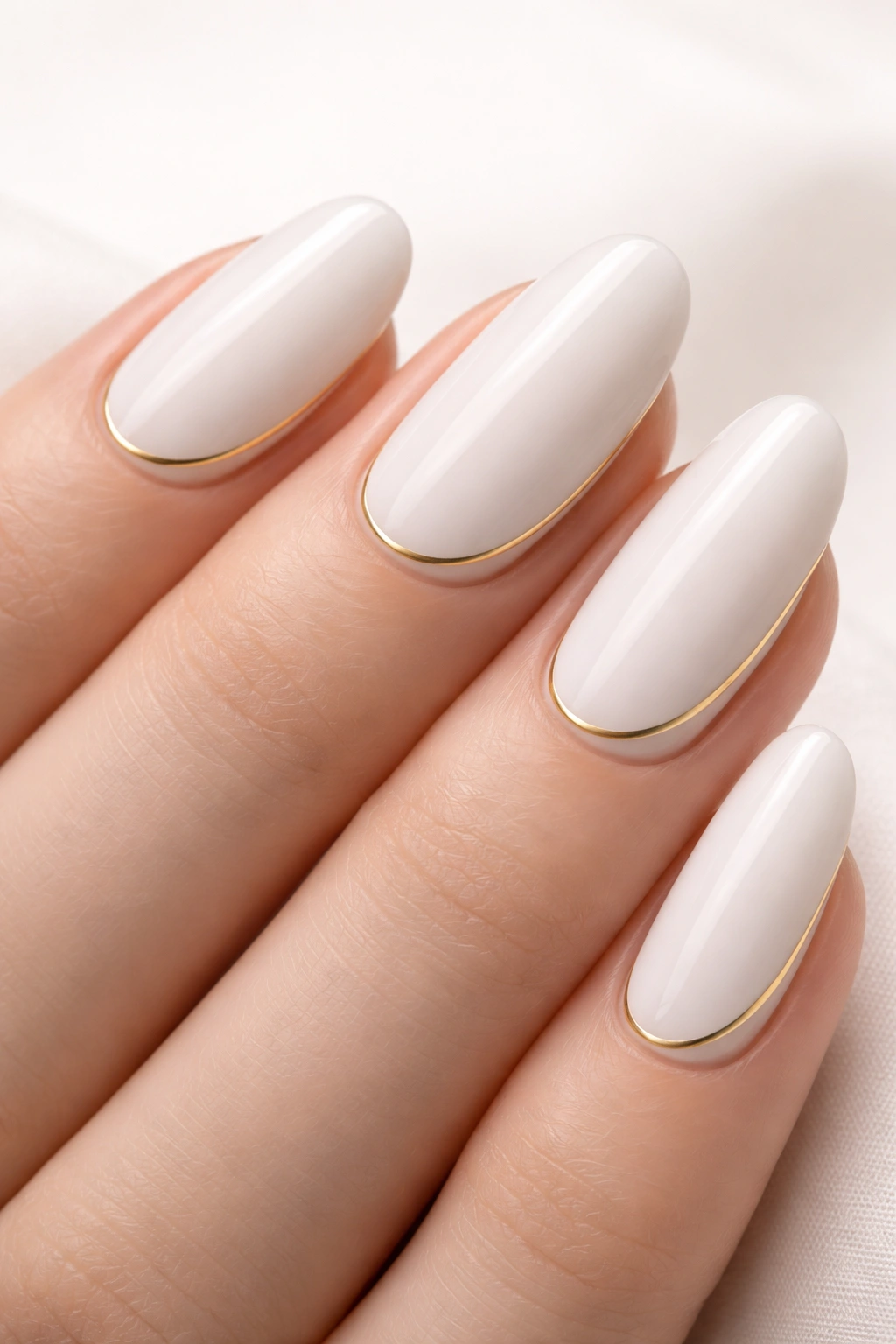 White nails with a single gold line accent
