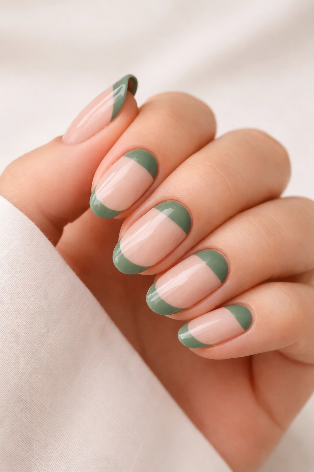 Nude nails with green half-moon at base