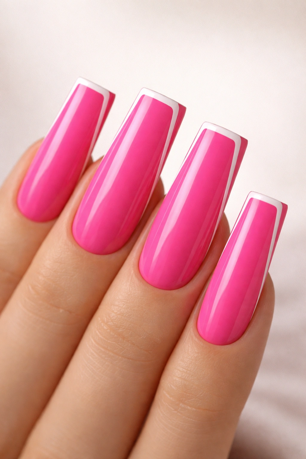 Close-up of minimalist hot pink duck nails with a thin white border