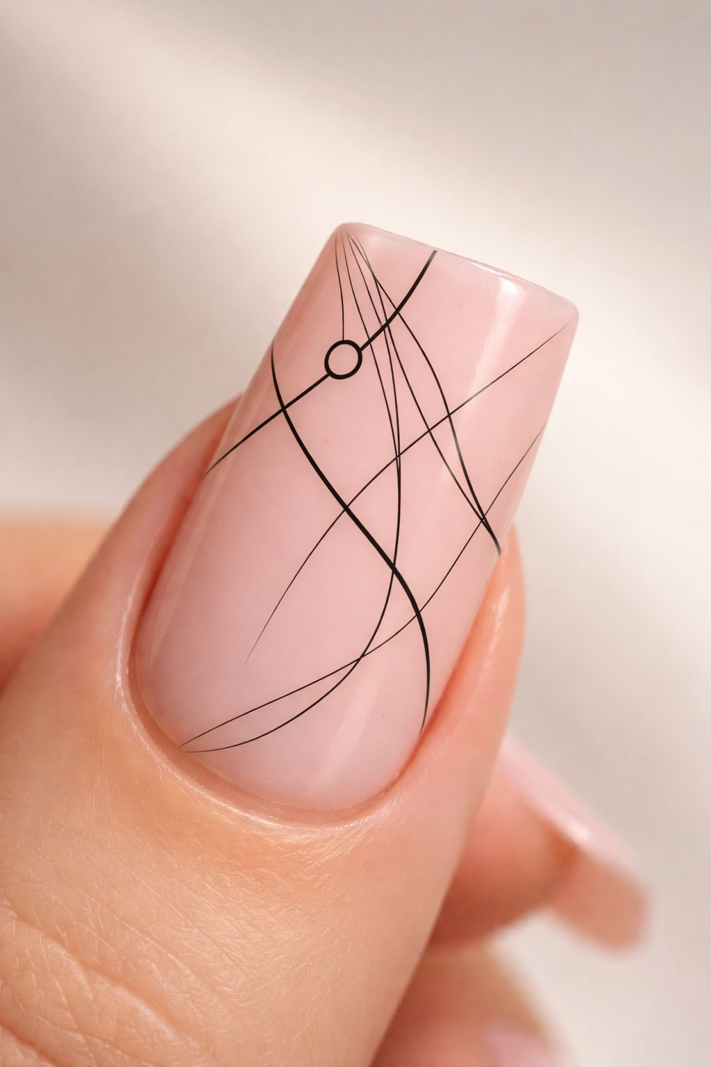 Close-up of a duck nail with minimalist black line art on pink base