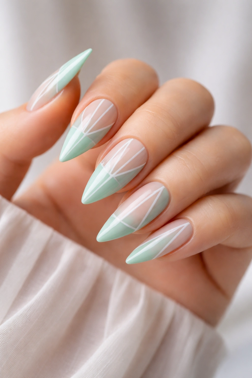 Mint green geometric stiletto nails with clean stripe patterns