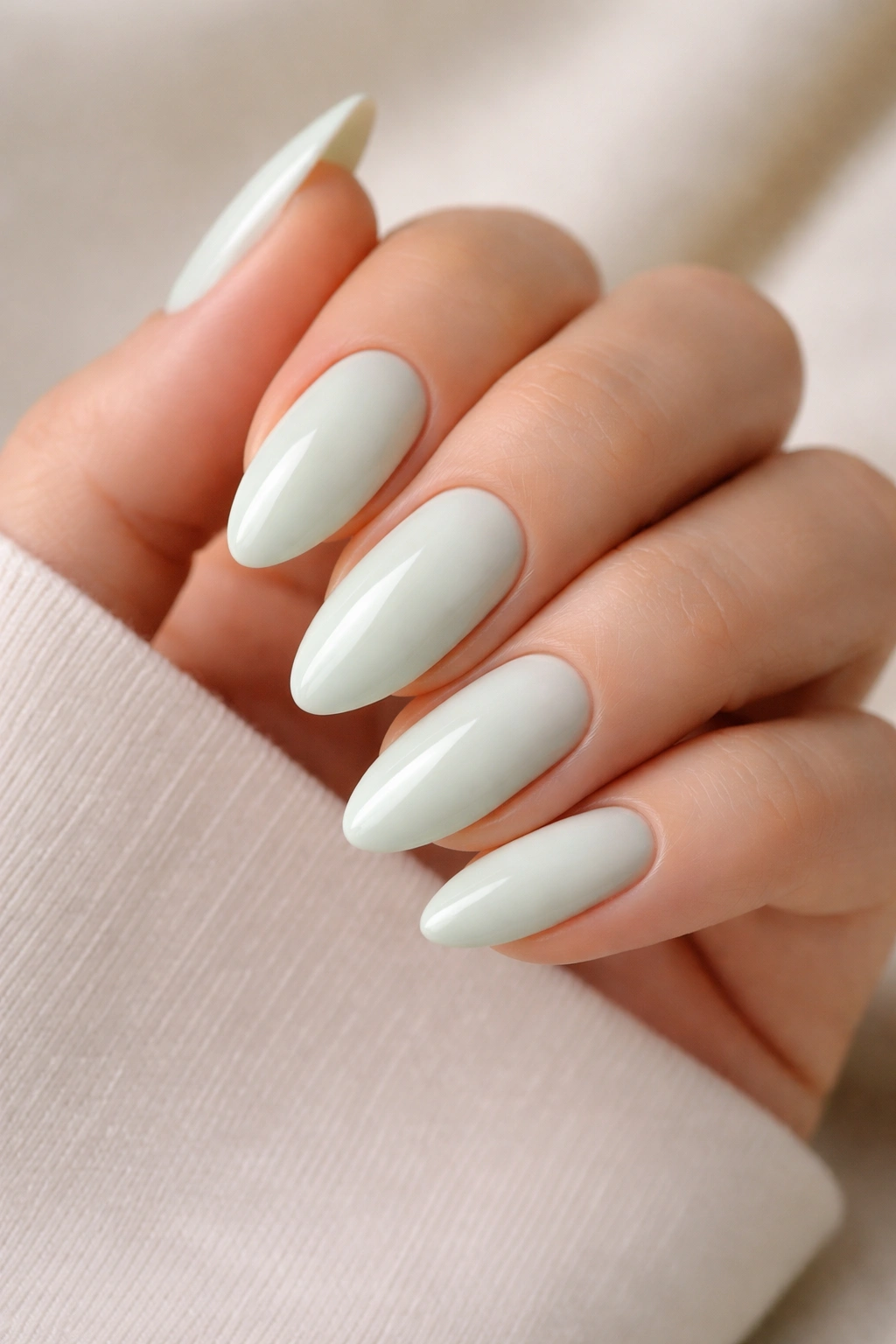 Almond nails in soft cream mint with glossy top coat