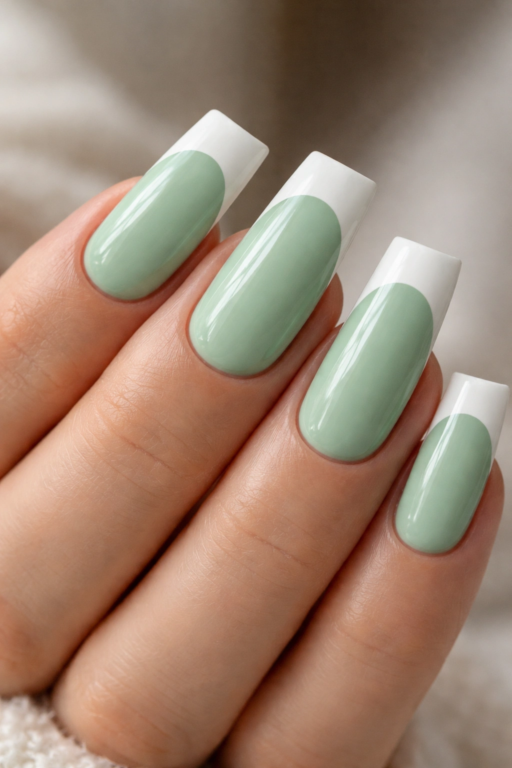 Duck nails in mint green with white French tips on a wide fan shape