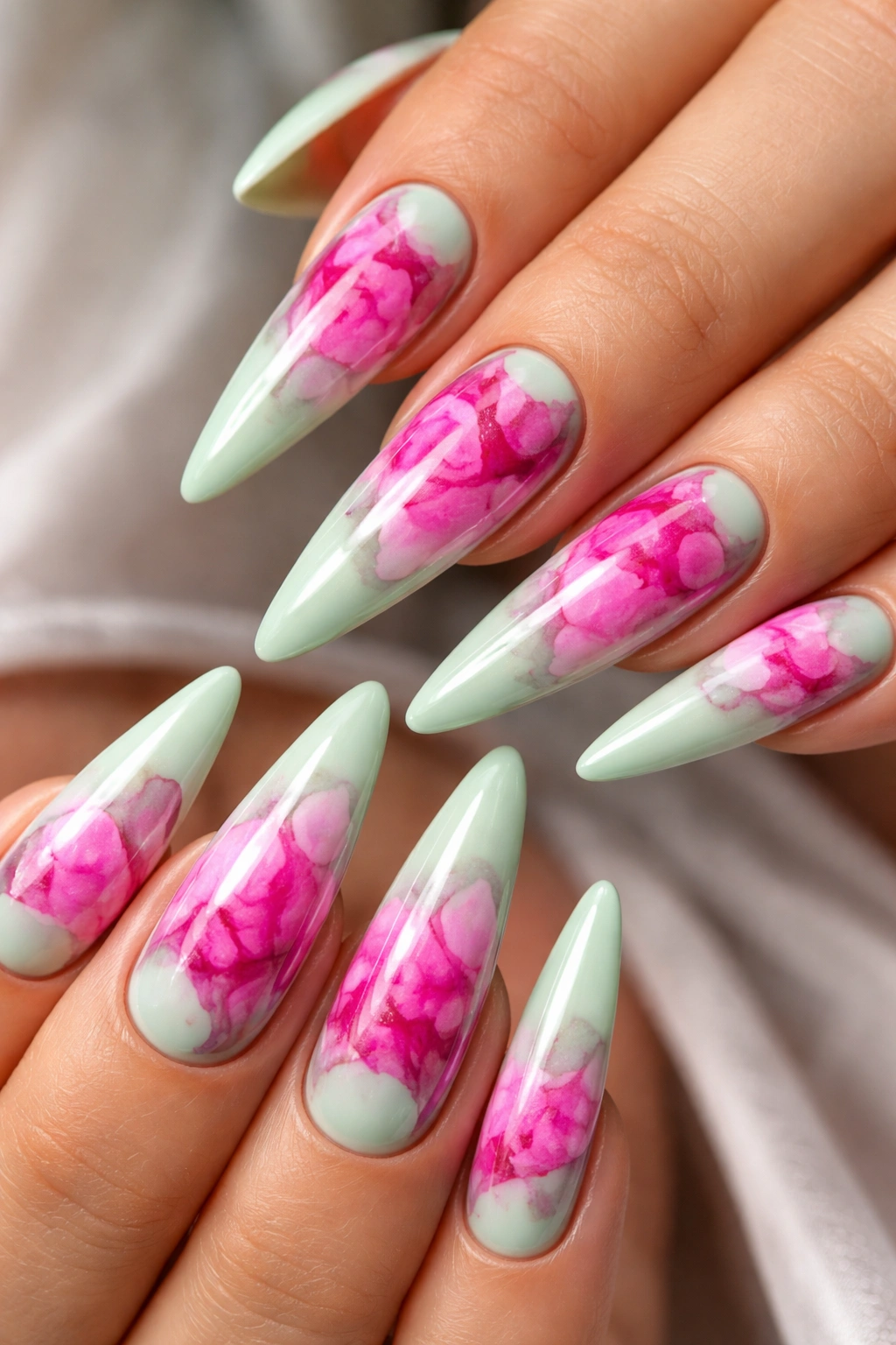 Close-up of mint green stilettos with hot pink marble inlays