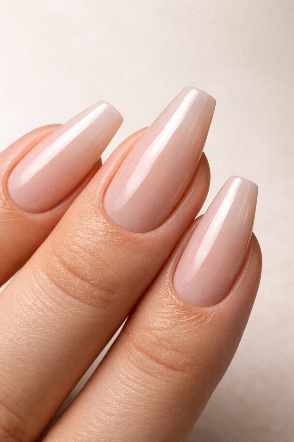 Close-up of a hand with a mis-proportioned coffin shape on a wide nail bed