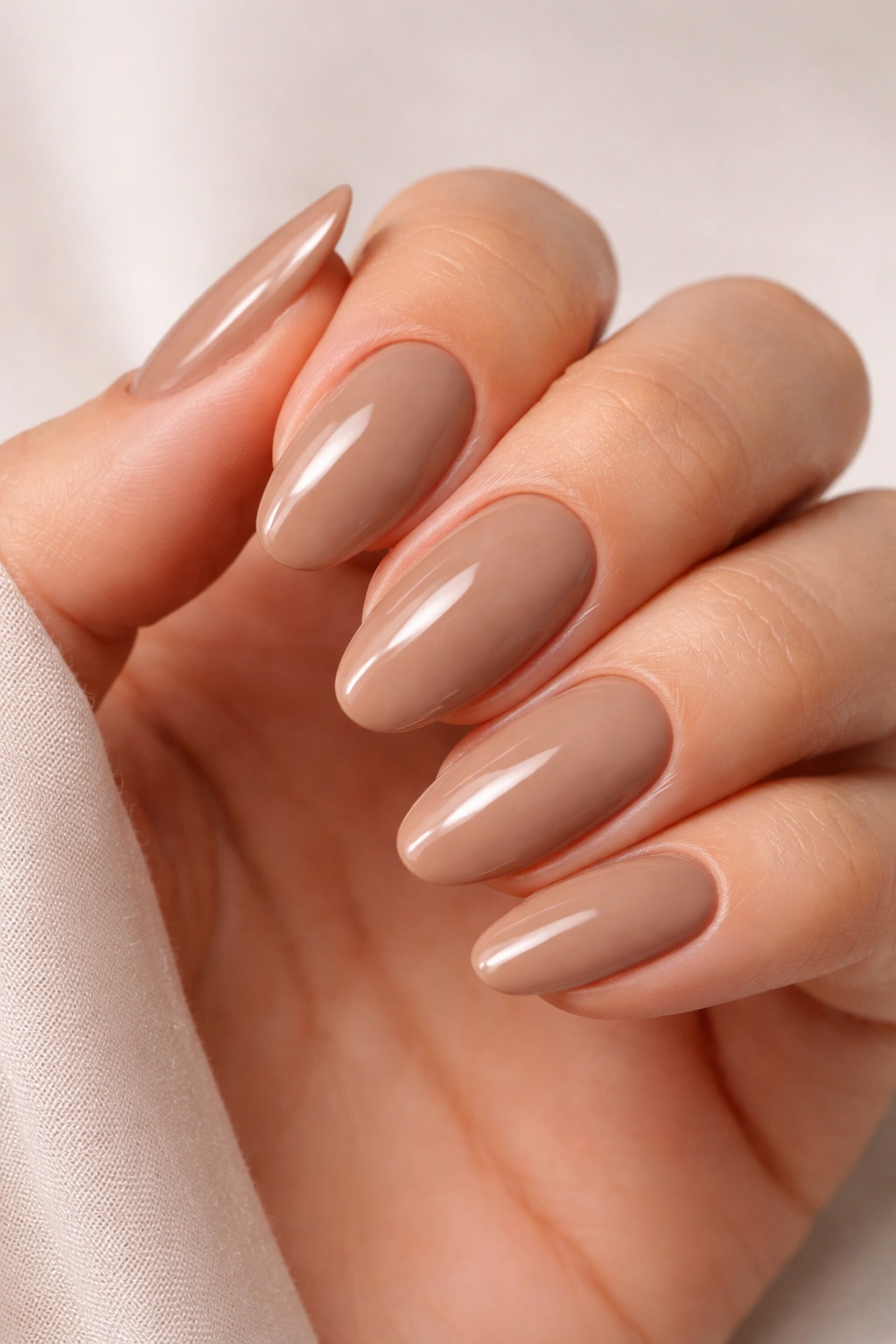 Mocha cream nails close-up in warm lighting
