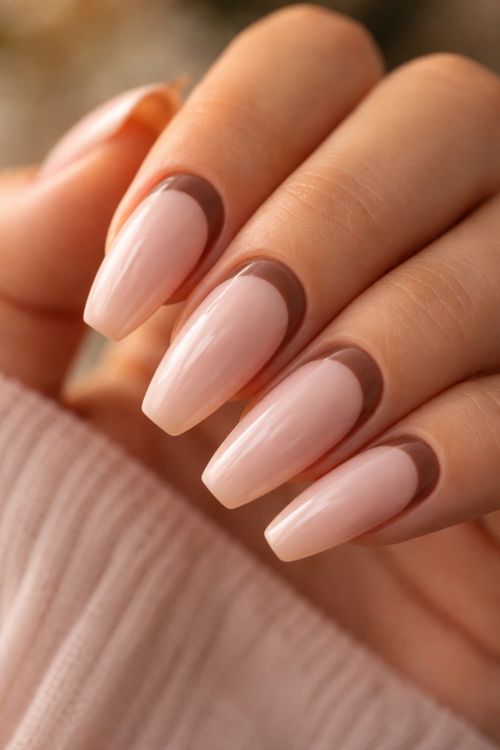 Nails with blush base and mocha half-moons at cuticle