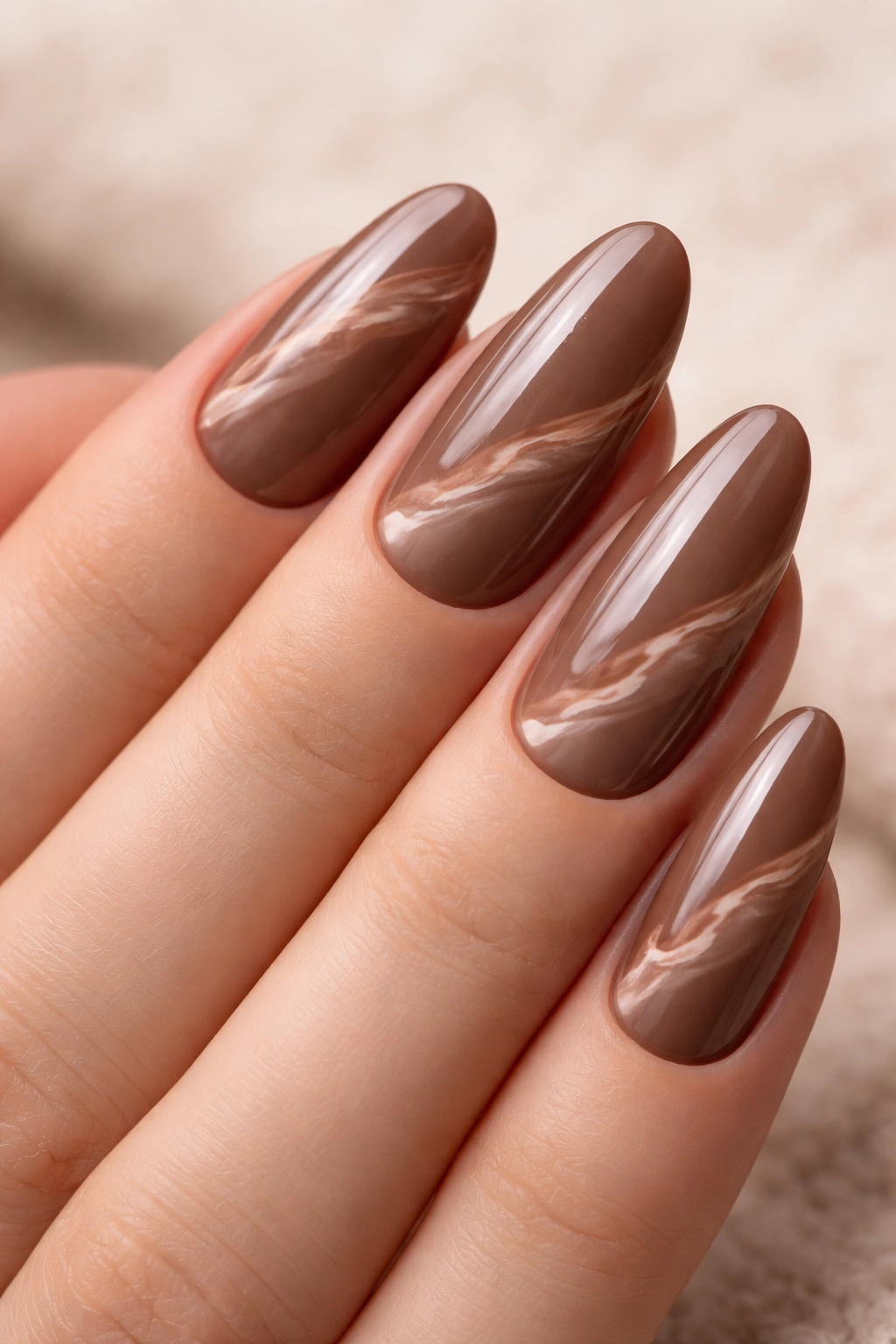 Mocha base with nude marble veining on long oval nails