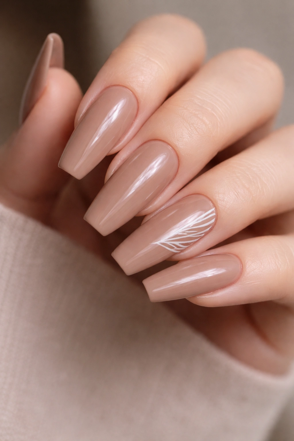 Mocha nude nails with single wing accent